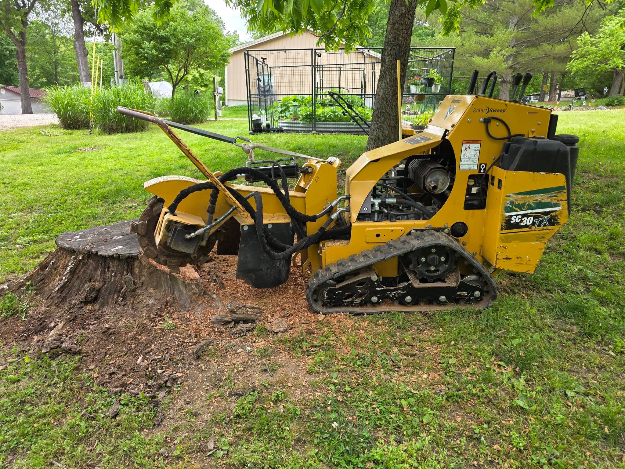 SC-30 stump grinder staged in front of mature woods