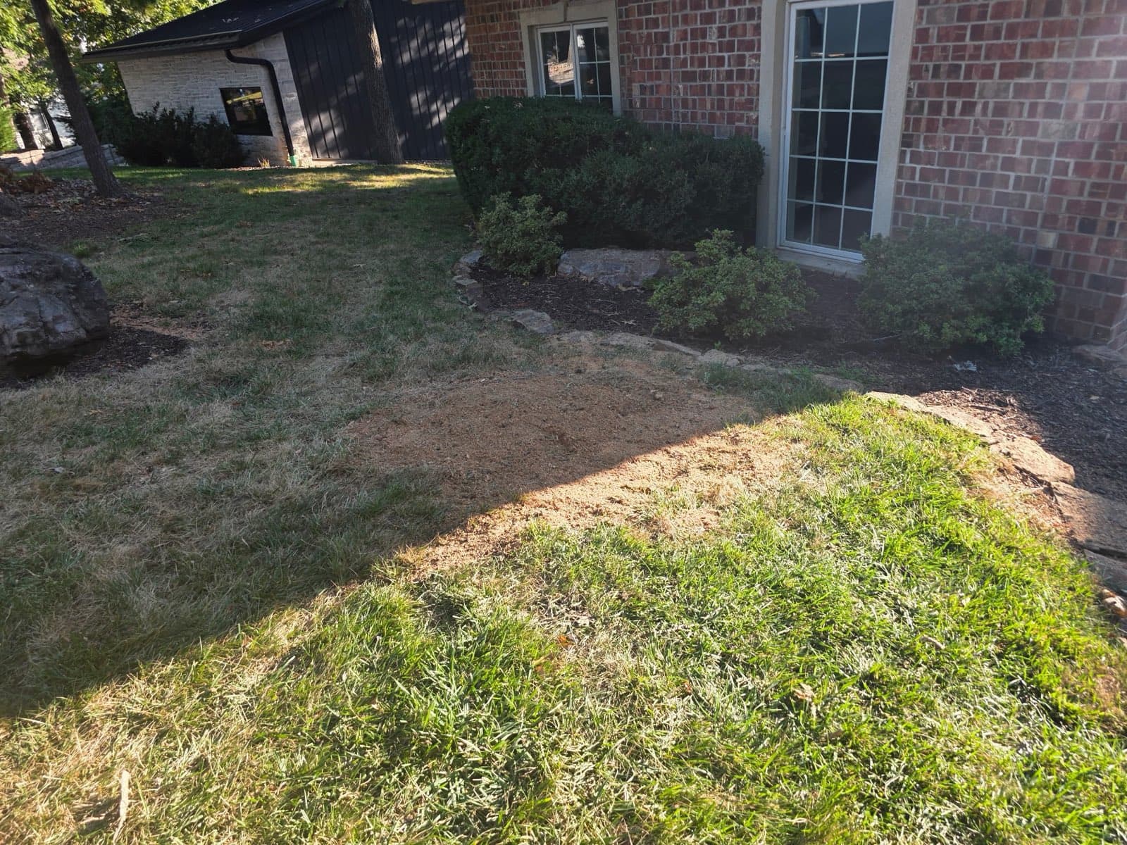 Same spot by the brick home with the stump ground out and the ground leveled